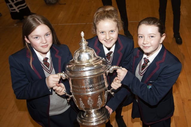Students take time to get a picture with the FAI Cup at Oakgrove Integrated College.
