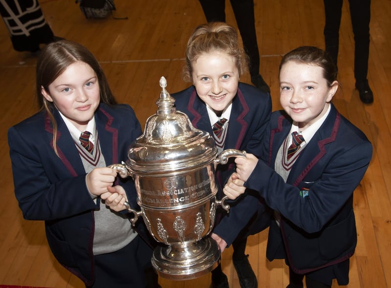 Students take time to get a picture with the FAI Cup at Oakgrove Integrated College.
