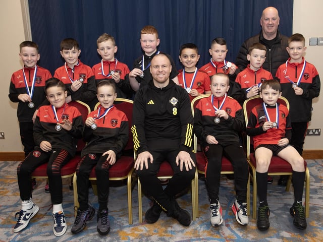 Ronan O'Donnell, Irish Football Association, special guest at the D&D Youth FA Annual Awards at the City Hotel on Friday pictured with Phoenix Swifts U9s, runners up in the Summer Cup. Included is coach Stephen Deeney. (Photos: Jim McCafferty Photography)