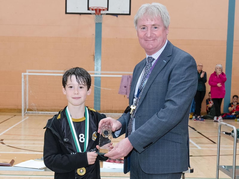 Tom Prigent, Model Primary School, being presented with the Bowl Trophy from Mr. Paul Kealey, Vice Principal, St. Joseph's Boys School on Thursday. (Photos: Jim McCafferty Photography)