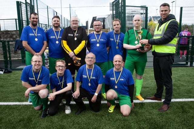 PEACE GAMES CHAMPIONS 2023. . . .Christopher Cooper, manager, Foyle Down Syndrome Trust, pictured handing over the 2023 Peace Games trophy to winners, Destined FC at the Waterside Shared Village pitches on Friday afternoon. (Photos: Jim McCafferty Photography)