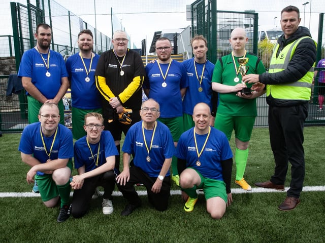 PEACE GAMES CHAMPIONS 2023. . . .Christopher Cooper, manager, Foyle Down Syndrome Trust, pictured handing over the 2023 Peace Games trophy to winners, Destined FC at the Waterside Shared Village pitches on Friday afternoon. (Photos: Jim McCafferty Photography)