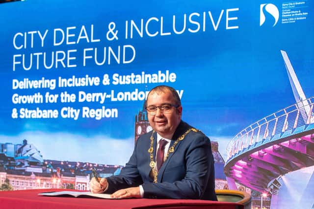 Former Mayor, Councillor Brian Tierney signing the Derry City and Strabane District City Deal Heads of Terms back in 2021.Picture Martin McKeown. 24.02.21
