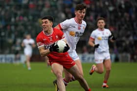 Conor McCluskey of Derry shields the ball from Tyroneâ€™s Aodhan Donaghy. Photo: George Sweeney