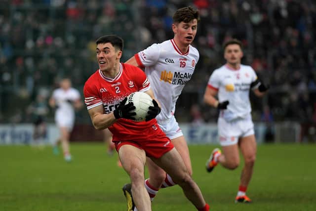 Conor McCluskey of Derry shields the ball from Tyroneâ€™s Aodhan Donaghy. Photo: George Sweeney