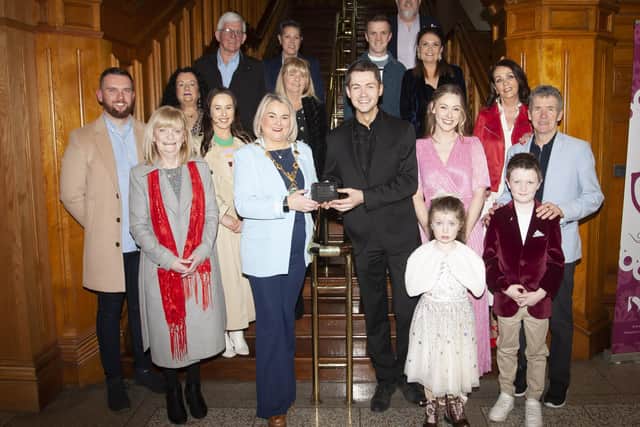 DAMIEN McGINTY HONOURED. . . . .The Mayor of Derry City and Strabane District Council, Sandra Duffy pictured making a special presentation to Damian McGinty in recognition of his recent success of getting to the finals of RTE’s Dancing With The Stars. Included are his wife, parents, siblings and family circle. (Photos: Jim McCafferty Photography)