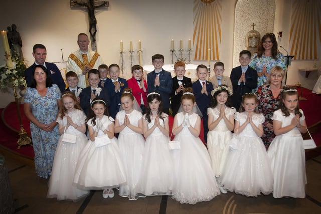 Pupils from Miss McDaid’s P4 Class at Greenhaw Primary School who received the Sacrament of First Holy Communion on Friday last at St. Brigid’s Church, Carnhill from Fr. Sean O’Donnell. Included in photo are Mr. Sean McLaughlin, Principal, Miss Devine,, Classroom Assistant and Miss McDaid, teacher. (Photo: Jim McCafferty Photography)