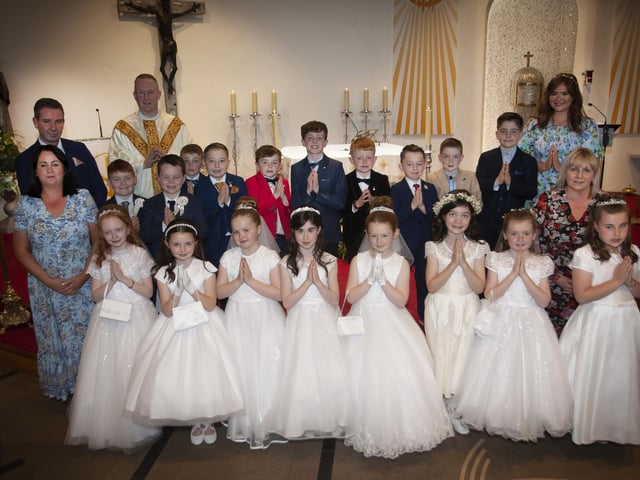 Pupils from Miss McDaid’s P4 Class at Greenhaw Primary School who received the Sacrament of First Holy Communion on Friday last at St. Brigid’s Church, Carnhill from Fr. Sean O’Donnell. Included in photo are Mr. Sean McLaughlin, Principal, Miss Devine,, Classroom Assistant and Miss McDaid, teacher. (Photo: Jim McCafferty Photography)