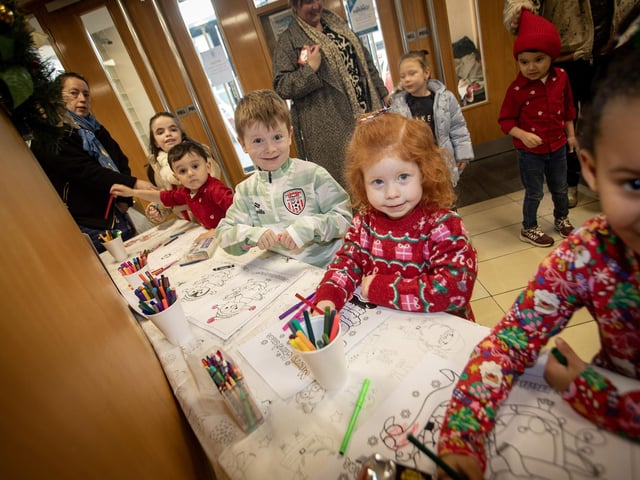 Some budding young artists show off their Santa Colouring Skills during Saturday's event at Derry Credit Union. : .