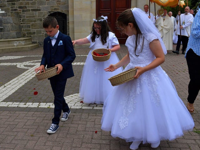 Children from schools in the Long Tower parish, who made their First Holy Communion recently, spread red petals on the ground during the Solemnity of Corpus Christi procession, on Sunday afternoon. Photo: George Sweeney. DER2324GS –