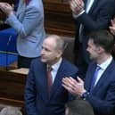 Micheál Martin is applauded by Simon Harris and Jack Chambers after he was elected Taoiseach on Thursday.