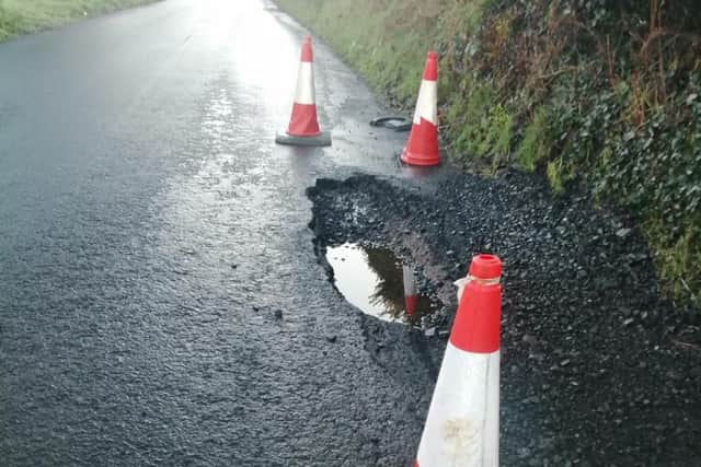 A pothole on a local road. The wettest October in over 153 years and a deficit in funds have impacted the state of the roads here, the Department for Infrastructure said.