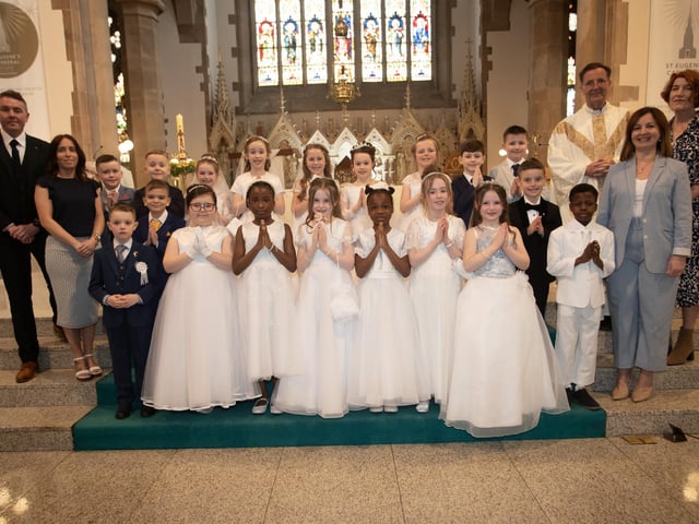 Pupils from Mr. Joe Kennedy's class at St. Eugene's Primary School who received the Sacrament of First Holy Communion from Fr. Shaun Doherty at St. Eugene's Cathedral on Friday last. Included are Ms. Gemma McIvor, teaching assistant, Mrs. Carol Duffy, principal and Ms. Joanne Sheerin, teaching assistant. (Photos: Jim McCafferty Photography)