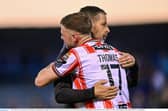 Could Dom Thomas, pictured here being congratulated by manager Tiernan Lynch, be on his way out of Brandywell this summer? Photo by Ramsey Cardy/Sportsfile