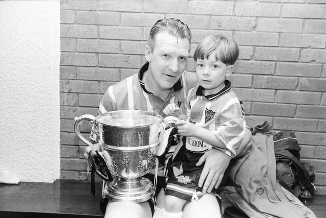 Derry City left-back Paul McLaughlin with a special supporter after the victory.