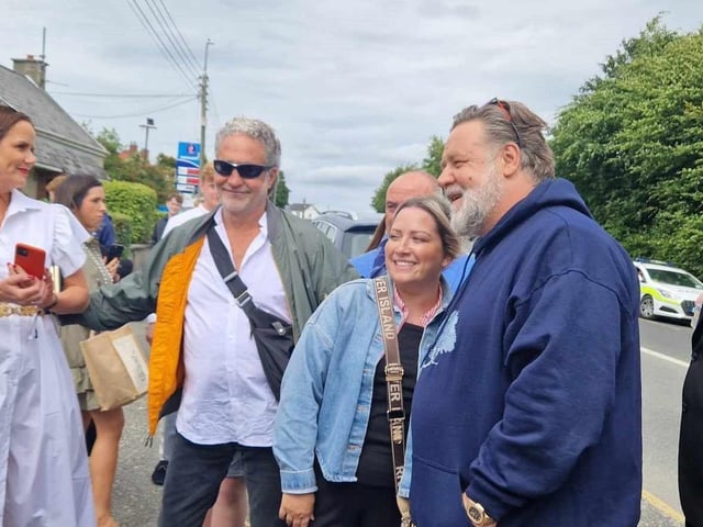 Russell Crowe takes a picture with a local fan.
