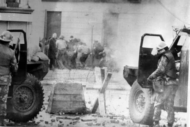 File photo dated 30/01/72 of soldiers taking cover behind their sandbagged armoured cars while dispersing rioters with CS gas in Londonderry. A judge will rule later on whether to admit "decisive" evidence to the trial of a former paratrooper accused of two murders on Bloody Sunday. Issue date: Wednesday September 24, 2025.