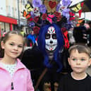 Allah and Arlo with the “Living Doll” in Waterloo Place on the 40th anniversary of the Halloween celebrations. (Photo - Tom Heaney, nwpresspics)
