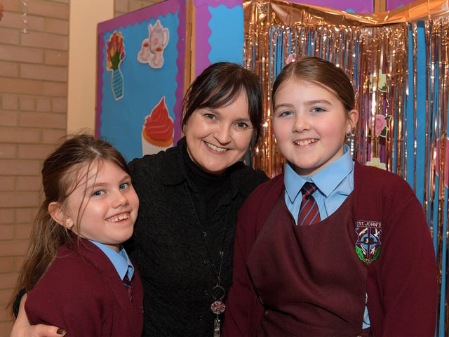 Teacher Mrs Cassidy with Amelia and Madeline at St John’s PS Grandparents Vintage Tea. Photo: George Sweeney