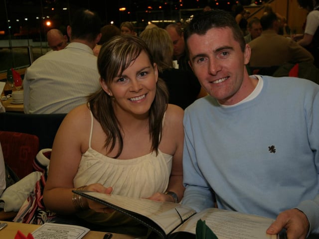 Carolanne Sinclair and Giles Moan check out the menu at the Lifford dog stadium 0008/JML : Parties across Derry in January 2006.