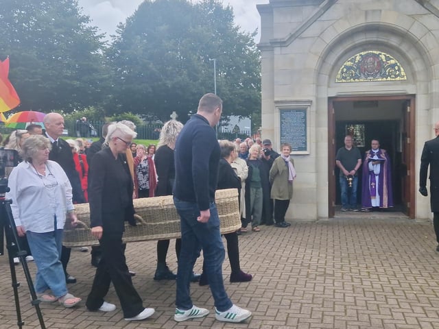 Nell McCafferty's casket is carried into the Long Tower on Friday.