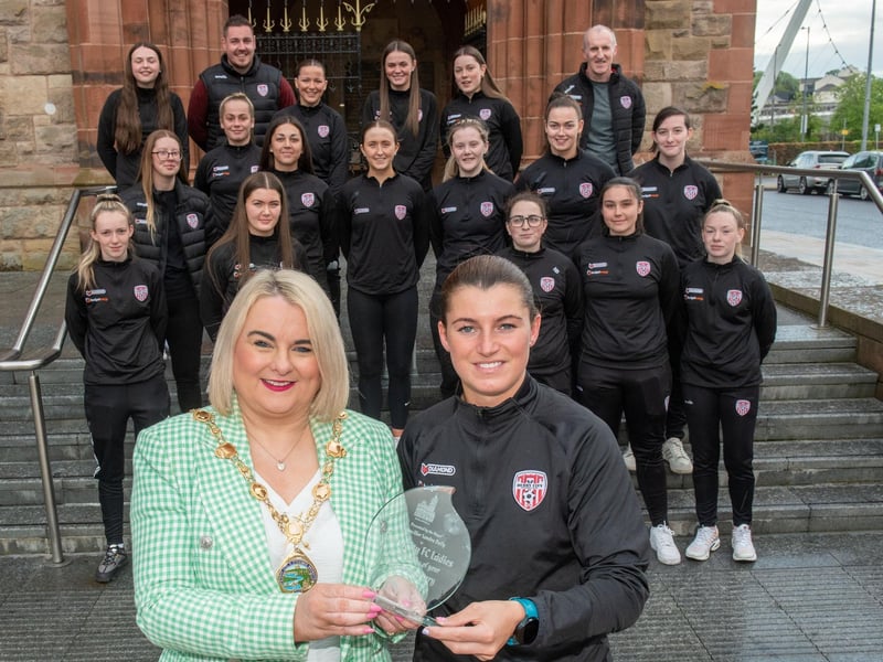 The Mayor Councillor Sandra Duffy pictured with Derry City Ladies Football team as she hosted a reception to mark their 20th anniversary. During the event the First Citizen presented a commemorative gift to captain, Shannon Dunne. The team were joined by coach Paul Dixon and Chairperson John Hegarty. Picture Martin McKeown. 05.05.23