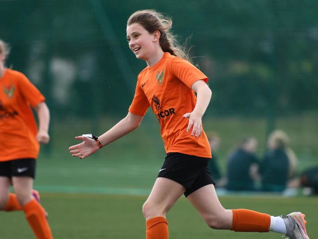 A Mid Ulster Ladies forward celebrates after scoring during a girls under-13's match.