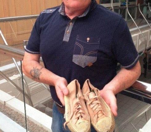 Annette's brother Martin with the shoes the schoolgirl was wearing when she was shot and killed.