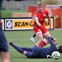 A CASE FOR THE DEFENCE . . . Cliftonville’s Odhran Casey with Larne's Dan Bent. Credit ©INPHO/Presseye