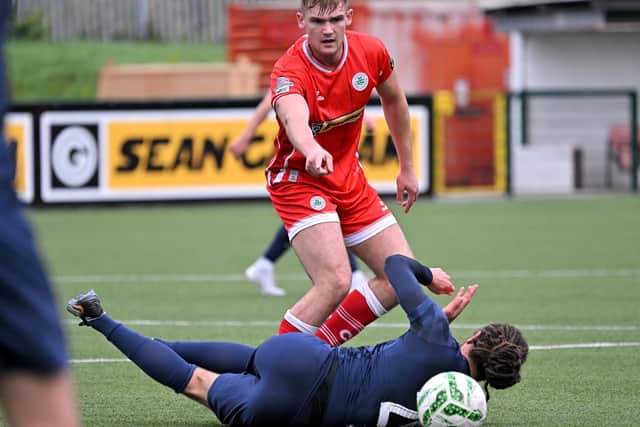 A CASE FOR THE DEFENCE . . . Cliftonville’s Odhran Casey with Larne's Dan Bent. Credit ©INPHO/Presseye