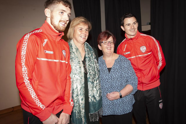 Members of the teaching staff get a photo taken with Derry City players Jamie McGonigle and Ciaran Coll at Oakgrove College.