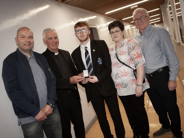 Fr. Michael Canny, board of governors, St. Columb's College presenting Damian McGuinness with the Best GCSE Result in Business Studies and Mathematics Award (co-winner) award at last week's prizegiving. Included on left is Rory Boyd's dad (co-winner), and on right, Damian's parents.