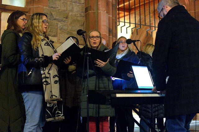 Choir singing at a candlelit vigil, held at Guildhall Square on Monday evening, to remember those who died in the Creeslough tragedy on Friday afternoon last.  Photo: George Sweeney.  DER2241GS – 49 