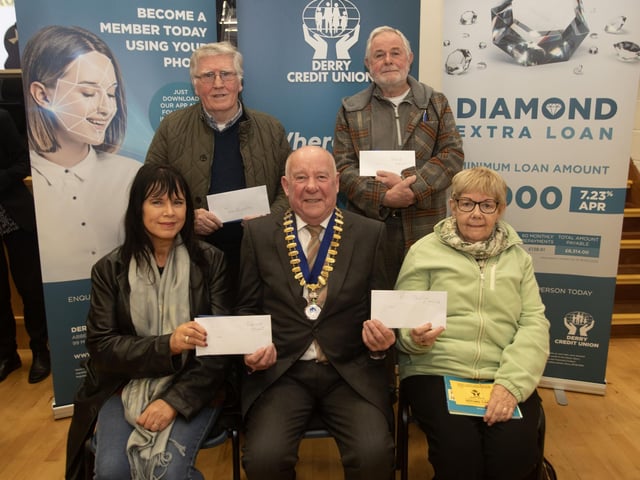 Derry Credit Union president Colm McCauley presenting the £250 prizewinners at Monday night's AGM. Front from left, Patricia Grant, Sheila Hynes, and at back, John Kennedy and Patrick Meenan. : .