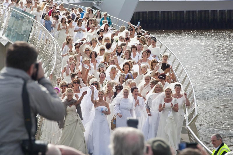 The brides make their way over the peace bridge. (2804-GMI-07)