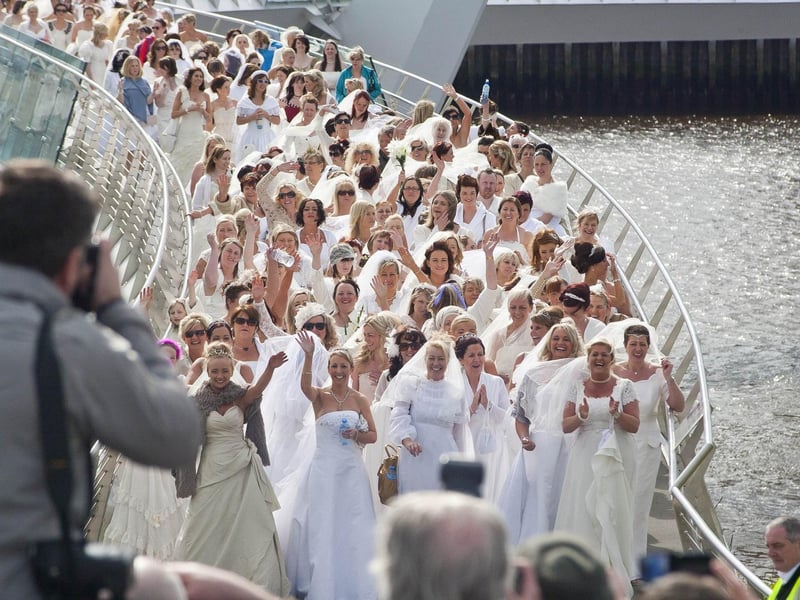 The brides make their way over the peace bridge. (2804-GMI-07)