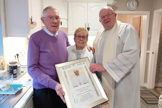 Jim and Mary Keys pictured with Fr Michael McCaughey, St Patrick's Pennyburn, Three Patrons parish, who celebrated Mass in their home to mark their 60th wedding anniversary on Saturday with the Papal Blessing they received from Pope Francis.