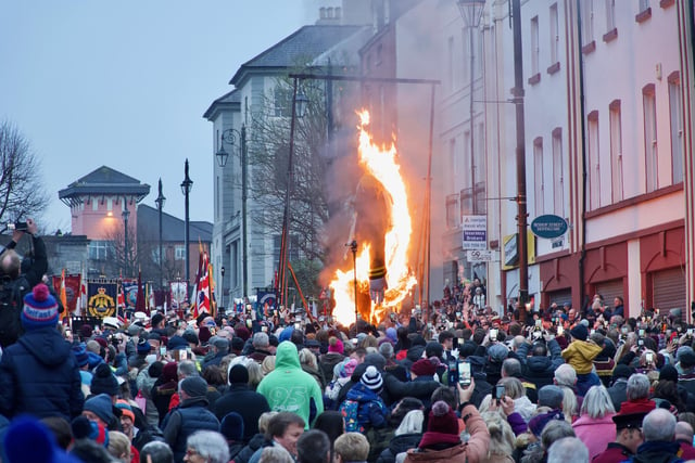 People looking on as an effigy of Colonel Robert Lundy goes up in flames.