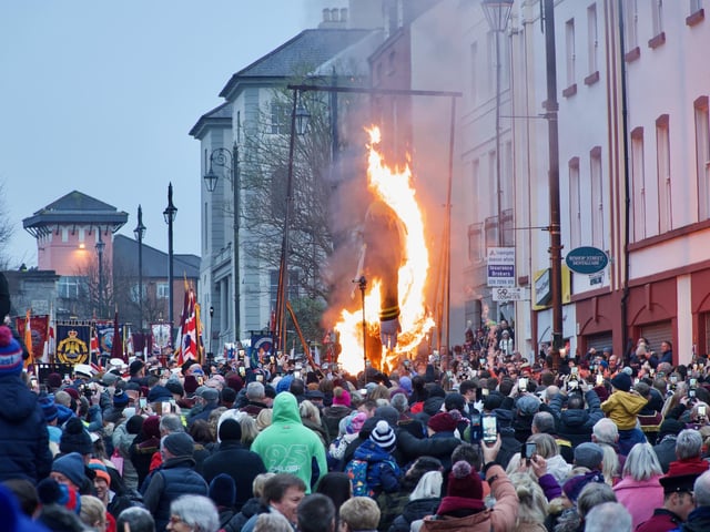 People looking on as an effigy of Colonel Robert Lundy goes up in flames.