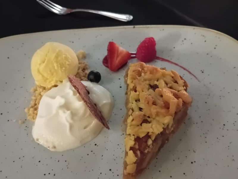 A desert of apple pie with vanilla ice cream at Kubicki.