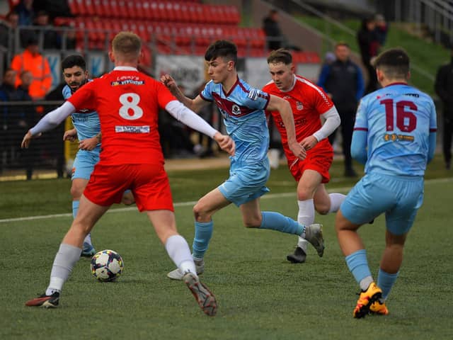Institute's Kirk McLaughlin battles to keep possession against Dergview.  Photo: George Sweeney