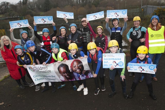 Mrs. Ciara Deane, principal, St. Joseph’s Boys School pictured with her staff and students who took part in the Children in Crossfire Pier Dive at the Creggan Reservoir on Saturday last. (Photos: Jim McCafferty Photography)