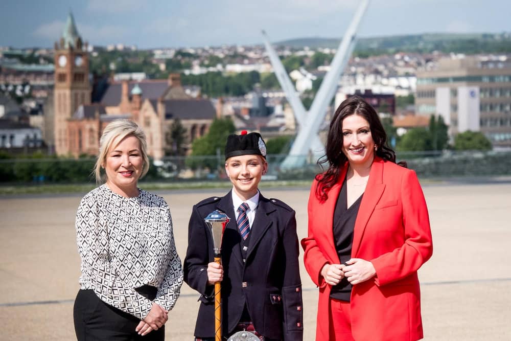 Pictured left to right are; First Minister Michelle O’Neill, Drum Major Jamie-Lee Wilson - Bready Ulster Scots Pipe Band and deputy First Minister Emma Little-Pengelly.