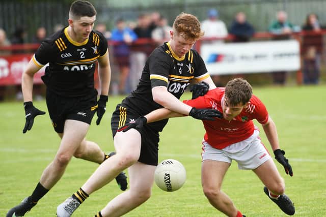 Niall Friel, Sean Dolan's, tangles with Doire Colmcille defender Callum Dunnion. (Photo: Keith Moore)