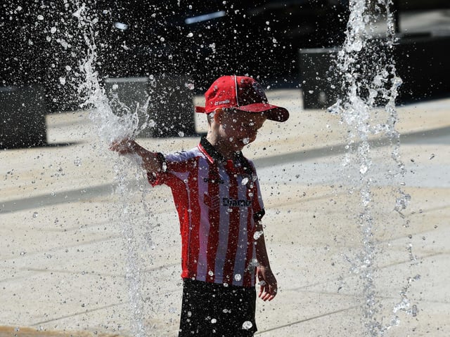 A youngster enjoying the fountains in the Guildhall Square.