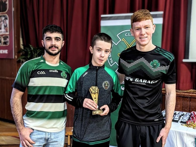 Daniel Doherty and Keelan Doherty present Sean Plummer with the U13 Most Improved award.