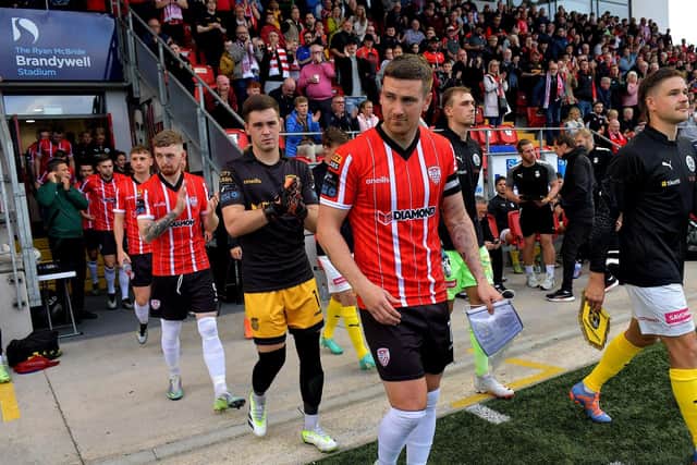 Captain Patrick McEleney, leads out the Derry City team at the Brandywell Stadium.