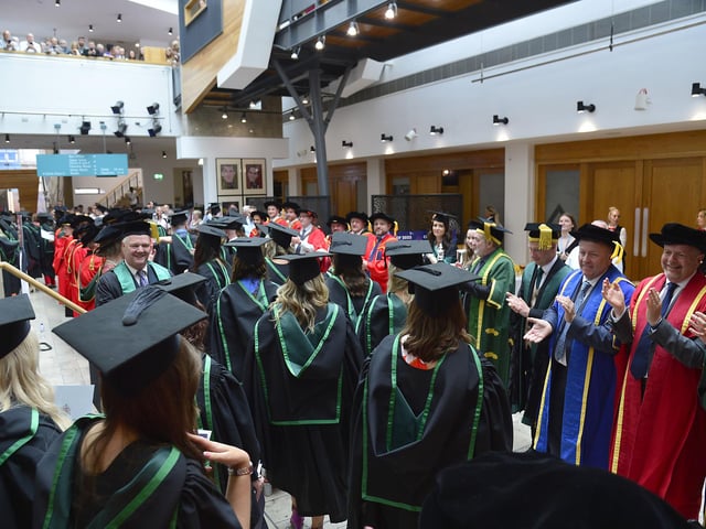 A round of applause for the graduates as they make their way through the Millennium Forum.