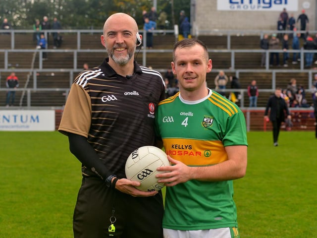 Connor Carville, captain of Watty Graham’s, Glen, presents the match ball to referee Gavin Hegarty at the end of the SFC final on Sunday afternoon, as part of the GAA’s Referee Respect Day. DER2243GS – 021