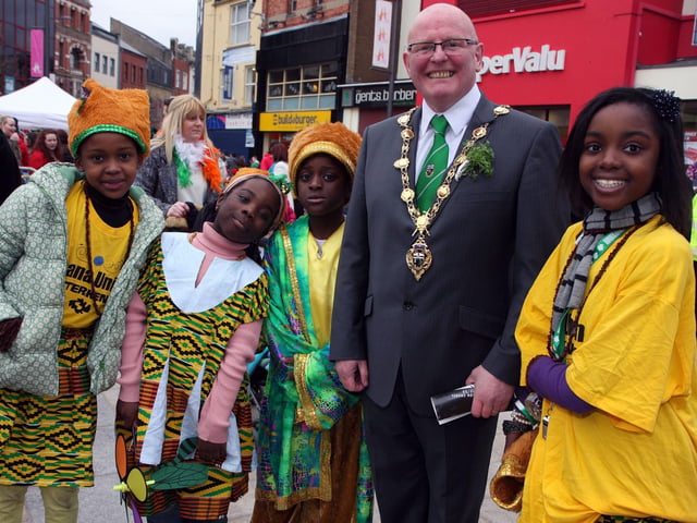 The Mayor of Derry Councillor Kevin Campbell, pictured with members of the Ghana Union dance group from Letterkenny, on his tour of Waterloo Place during the St. Patrick’s Day celebrations on Sunday.